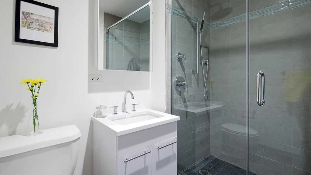 Glass-Enclosed Shower with Handheld Sprayer